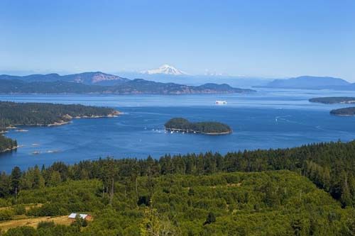 Salt Spring Island summer vista across the Gulf Islands with a snow-capped mountain on the horizon